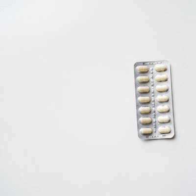 Finasteride pills in a blister pack on a clean white surface, prescription medication, no text, no words, no typography, no labels, clean image